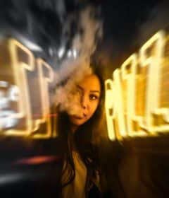 woman near yellow neon sign